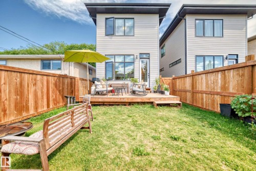 Rear view of house featuring a wooden deck and a fenced backyard - 8321 80 Avenue, Edmonton, AB - Outdoor With Deck Patio Veranda With Exterior