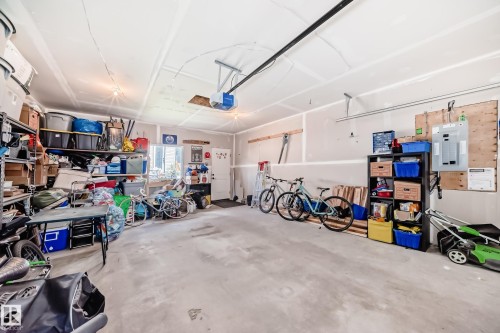 Garage featuring electric panel and a garage door opener - 8321 80 Avenue, Edmonton, AB - Indoor Photo Showing Garage
