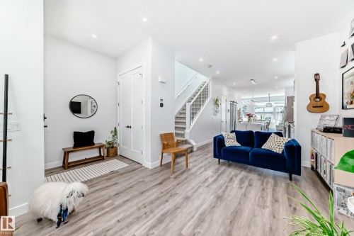 Living room featuring stairs, light wood-style floors, and recessed lighting - 8321 80 Avenue, Edmonton, AB - Indoor