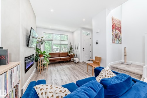Living room featuring wood finished floors and recessed lighting - 8321 80 Avenue, Edmonton, AB - Indoor