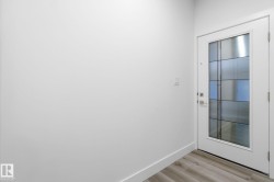 Doorway to outside with baseboards and wood finished floors - 