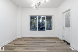 Unfurnished dining area featuring light wood-style floors and baseboards - 