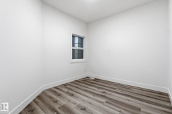 Unfurnished room with wood finished floors and baseboards - 