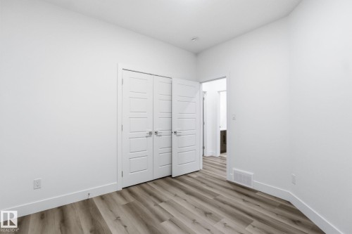 Unfurnished bedroom featuring light wood finished floors and a closet - 2532 210 Street, Edmonton, AB - Indoor Photo Showing Other Room