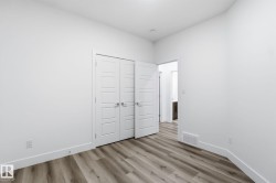 Unfurnished bedroom featuring light wood finished floors and a closet - 