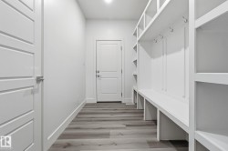 Mudroom featuring light wood-type flooring and baseboards - 