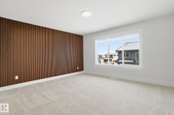 Spare room featuring wood walls, light carpet, and an accent wall - 