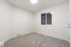 Carpeted spare room with baseboards - 