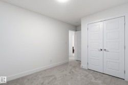 Unfurnished bedroom featuring light colored carpet and a closet - 