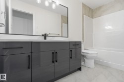 Full bathroom with vanity, tub / shower combination, and light marble finish floors - 
