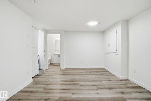 Unfurnished bedroom with light wood-style floors and ensuite bath - 2532 210 Street, Edmonton, AB - Indoor Photo Showing Other Room