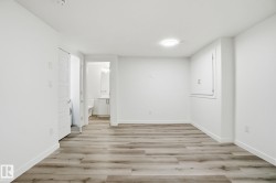 Unfurnished bedroom with light wood-style floors and ensuite bath - 