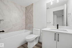 Bathroom featuring vanity, wood finished floors, and shower / bath combination - 