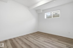 Empty room with wood finished floors and beam ceiling - 