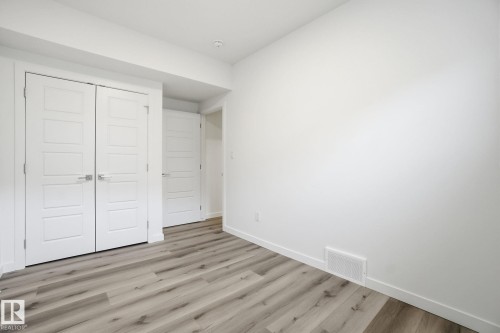 Unfurnished bedroom featuring a closet and light wood-style flooring - 2532 210 Street, Edmonton, AB - Indoor Photo Showing Other Room