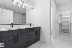 Full bathroom featuring double vanity, a stall shower, light marble finish flooring, and a walk in closet - 