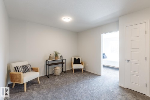 Sitting room featuring carpet floors - 3617 Triomphe Boulevard, Beaumont, AB - Indoor