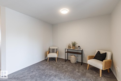 Sitting room with carpet and baseboards - 3617 Triomphe Boulevard, Beaumont, AB - Indoor
