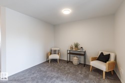 Sitting room with carpet and baseboards - 