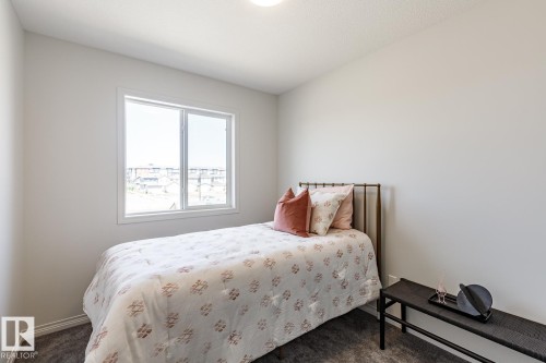 Bedroom with carpet flooring - 3617 Triomphe Boulevard, Beaumont, AB - Indoor Photo Showing Bedroom