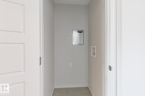 Washroom with hookup for a washing machine and baseboards - 3617 Triomphe Boulevard, Beaumont, AB - Indoor Photo Showing Other Room