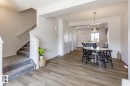 Dining room featuring stairway and light wood-style flooring - 3617 Triomphe Boulevard, Beaumont, AB  - Indoor Photo Showing Other Room 