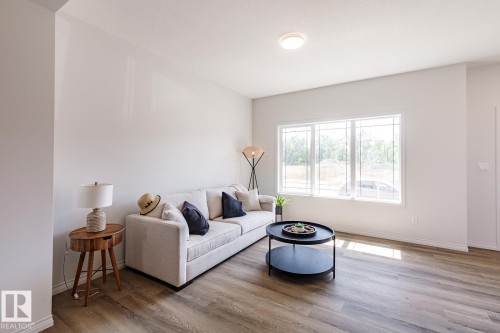 Living area featuring light wood-style floors - 3617 Triomphe Boulevard, Beaumont, AB - Indoor Photo Showing Living Room