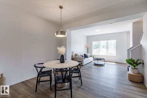 Dining area with wood finished floors and stairs - 3617 Triomphe Boulevard, Beaumont, AB - Indoor