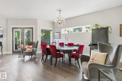 Dining area with light wood-type flooring and a chandelier - 11121 81 Avenue, Edmonton, AB - Indoor With Fireplace