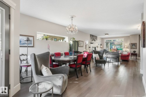 Dining area featuring a chandelier and wood finished floors - 11121 81 Avenue, Edmonton, AB - Indoor