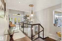 Stairway with french doors, wood finished floors, and recessed lighting - 