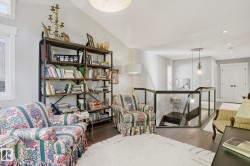 Living area with an upstairs landing, wood finished floors, recessed lighting, and plenty of natural light - 