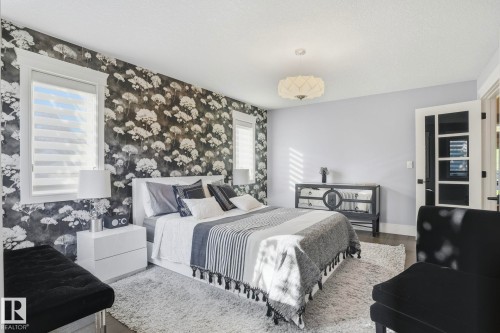 Bedroom with wood finished floors and wallpapered walls - 11121 81 Avenue, Edmonton, AB - Indoor Photo Showing Bedroom