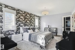 Bedroom with wood finished floors and wallpapered walls - 