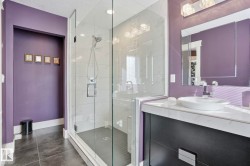 Bathroom with a shower stall, vanity, dark tile patterned floors, and a textured ceiling - 
