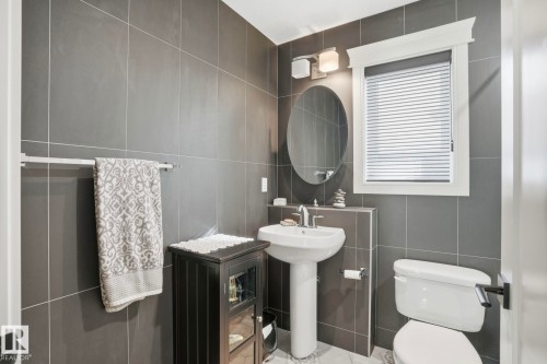 Bathroom with tile walls and toilet - 11121 81 Avenue, Edmonton, AB - Indoor Photo Showing Bathroom