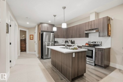 Kitchen featuring appliances with stainless steel finishes, light countertops, backsplash, decorative light fixtures, and recessed lighting - 11121 81 Avenue, Edmonton, AB - Indoor Photo Showing Kitchen