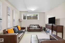 Carpeted living room with a textured ceiling - 