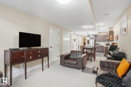 Living area featuring light carpet and a textured ceiling - 11121 81 Avenue, Edmonton, AB - Indoor Photo Showing Living Room