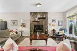 Living room with wood finished floors and a fireplace - 