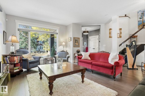 Living room with stairway and wood finished floors - 11121 81 Avenue, Edmonton, AB - Indoor Photo Showing Living Room