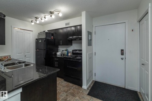 215 5810 Mullen Place, Edmonton, AB - Indoor Photo Showing Kitchen With Double Sink
