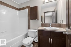 Full bathroom featuring vanity, shower / washtub combination, and a textured ceiling - 