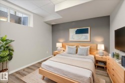 Bedroom featuring light wood finished floors and a drop ceiling - 