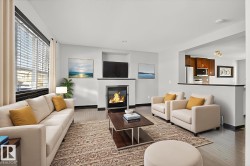 Living area with a glass covered fireplace and hardwood / wood-style floors - 