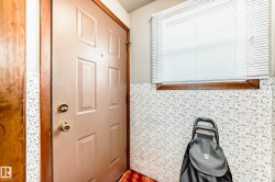 Interior space featuring tile walls and a wainscoted wall - 