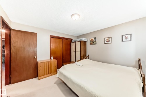 Carpeted bedroom with two closets - 12028 87 Street, Edmonton, AB - Indoor Photo Showing Bedroom