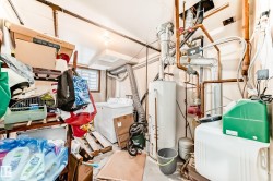 Utility room featuring gas water heater and washer and dryer - 