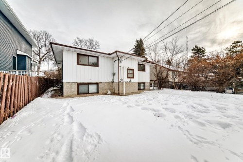 Snow covered back of property featuring board and batten siding - 12028 87 Street, Edmonton, AB - Outdoor