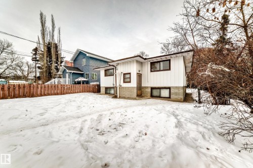 Rear view of property featuring board and batten siding and stone siding - 12028 87 Street, Edmonton, AB - Outdoor